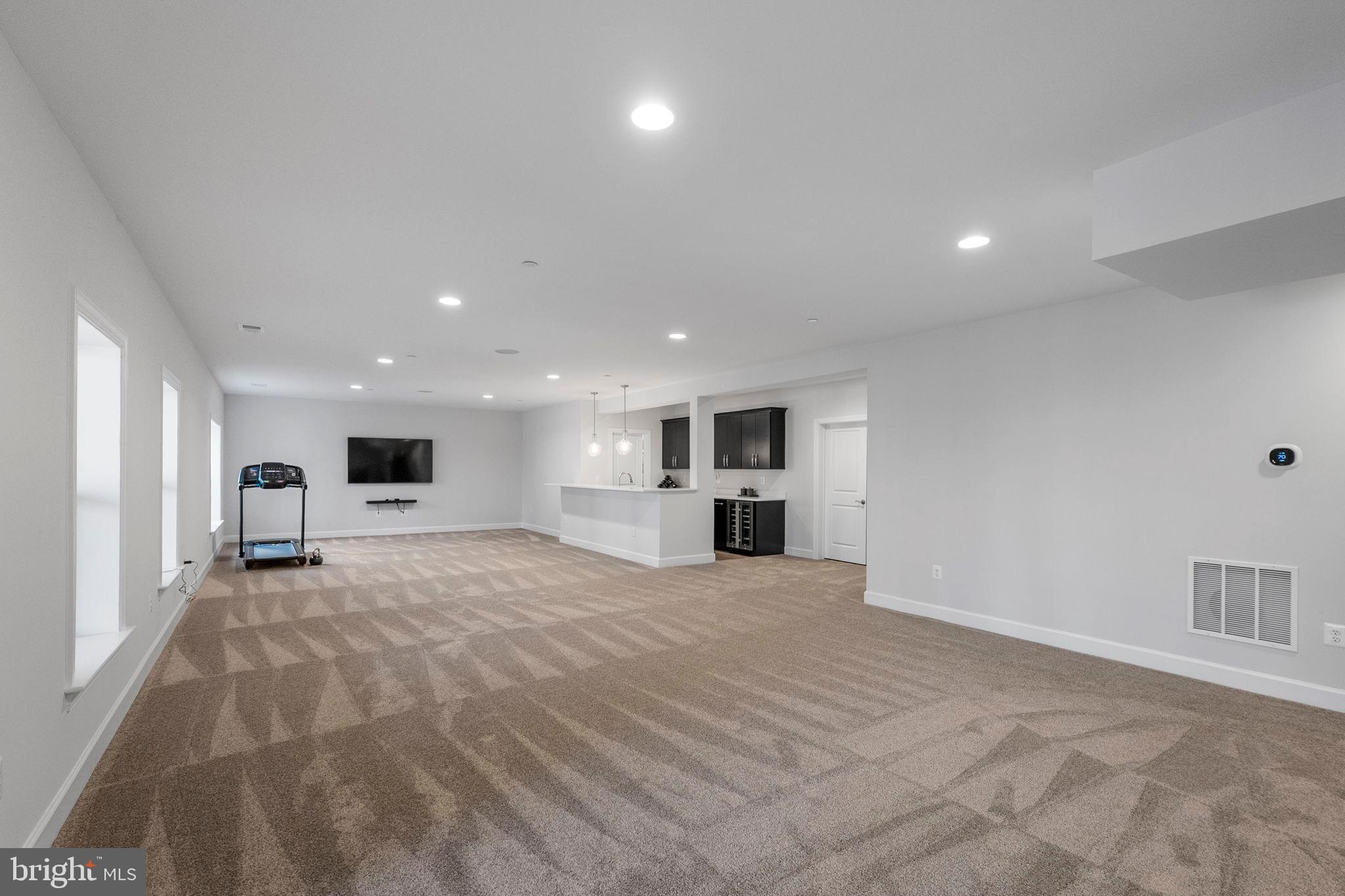 11760 Glen Mill Road Potomac, MD 20854 - Photo 46 of 64 a large white kitchen with kitchen island a sink stainless steel appliances and cabinets