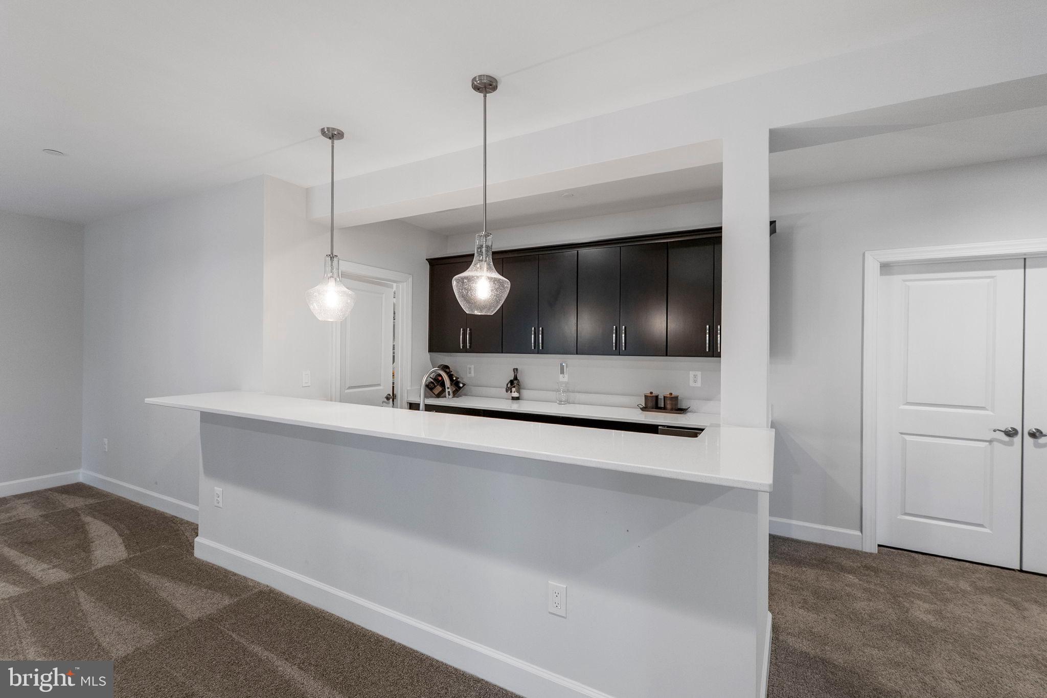 11760 Glen Mill Road Potomac, MD 20854 - Photo 47 of 64 a living room with a flat screen tv a sink and a potted plant