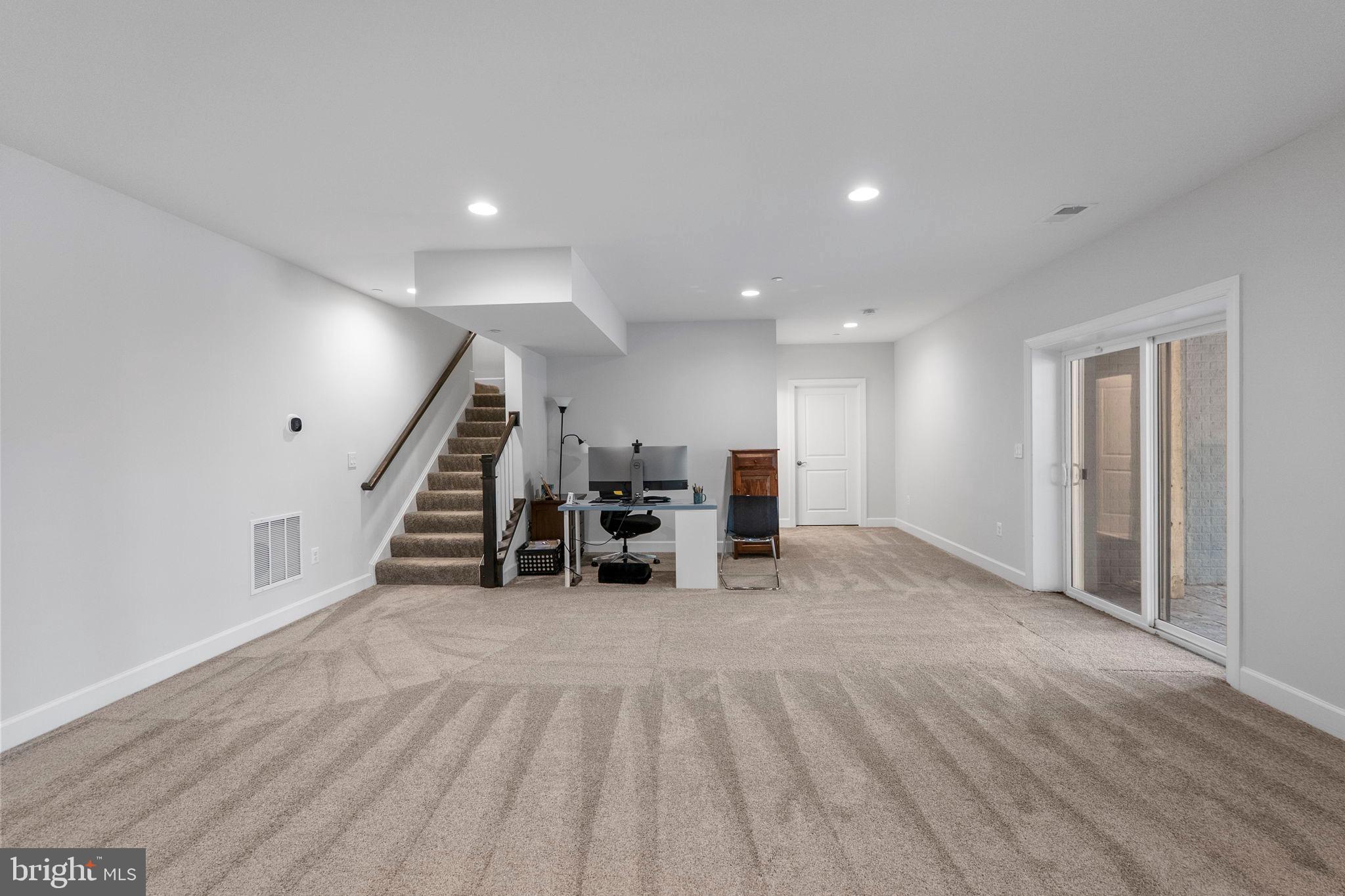 11760 Glen Mill Road Potomac, MD 20854 - Photo 48 of 64 a view of an empty room with wooden floor and stairs