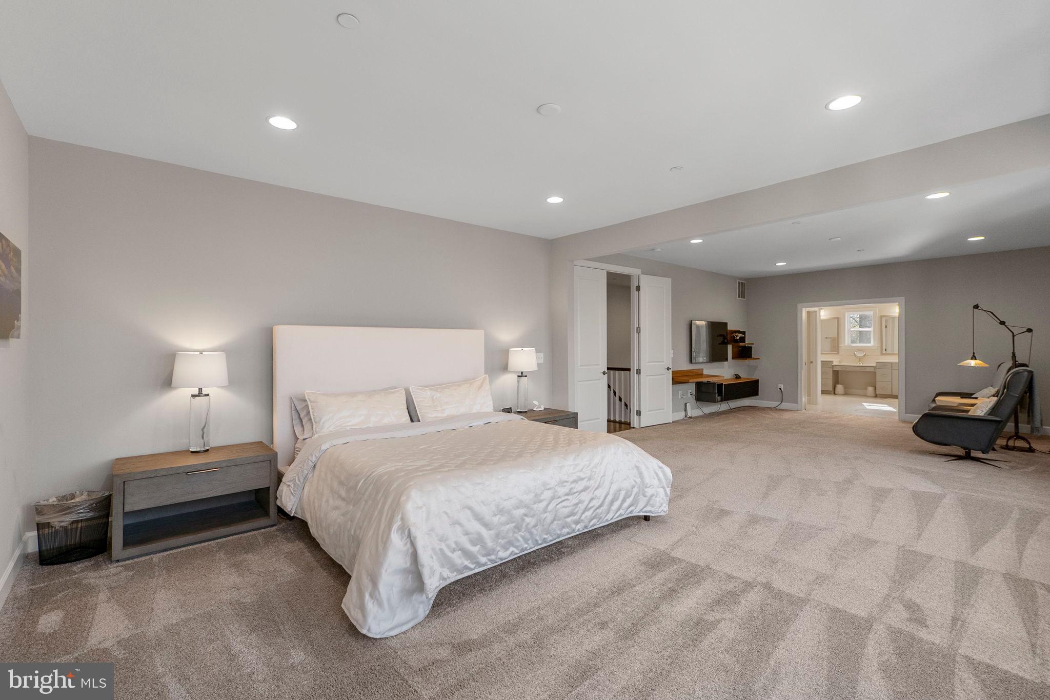11760 Glen Mill Road Potomac, MD 20854 - Photo 7 of 64 a spacious bedroom with a bed a lamp and a couch