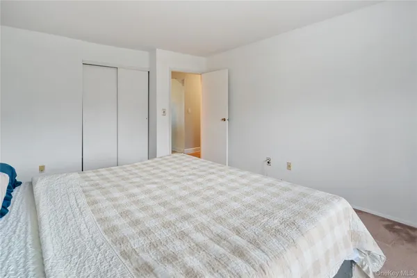 a large white bed in a white room