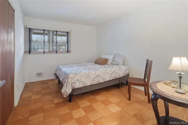 a bedroom with a bed and a table in it