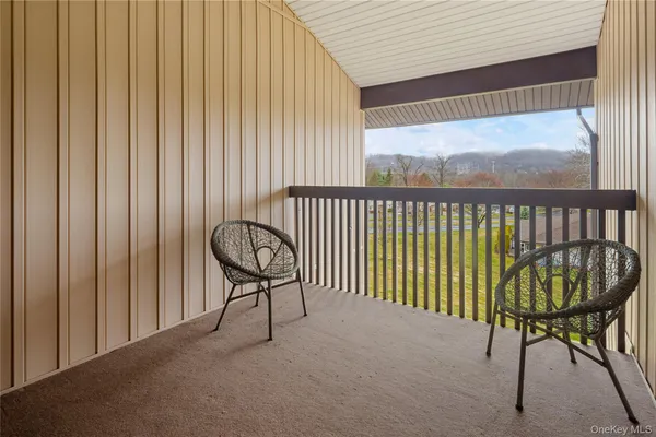 a balcony with table and chairs