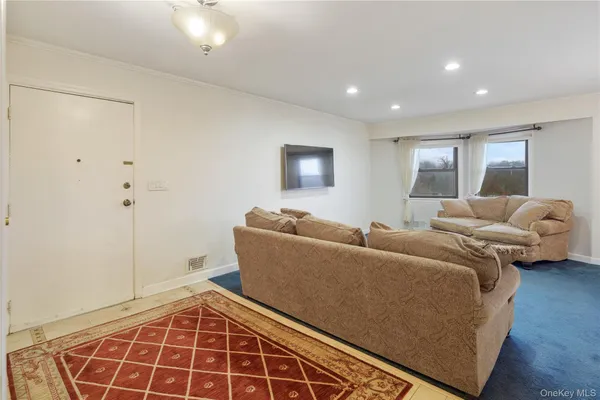 a living room with furniture and a rug