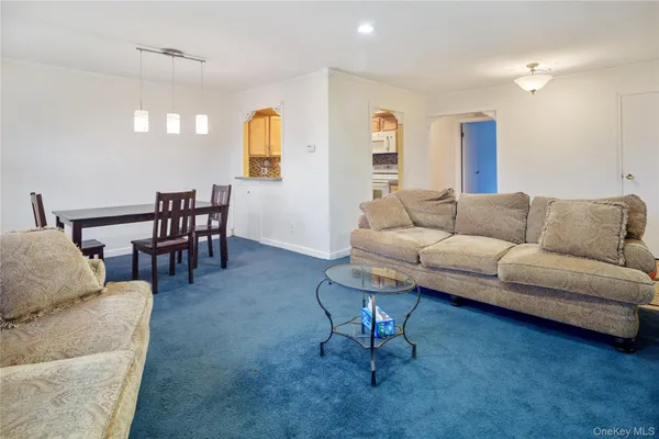 a living room with furniture wooden floor and dining table