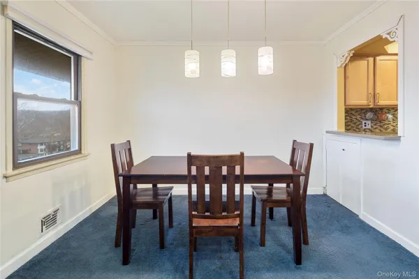 a view of a dining room with furniture and window