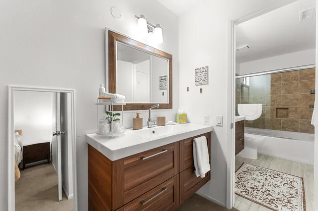 a bathroom with a sink a toilet and shower