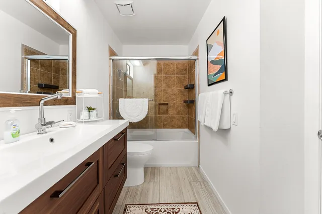 a bathroom with a sink a mirror and a bathtub