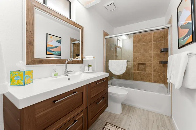 a bathroom with a sink a toilet and a bathtub