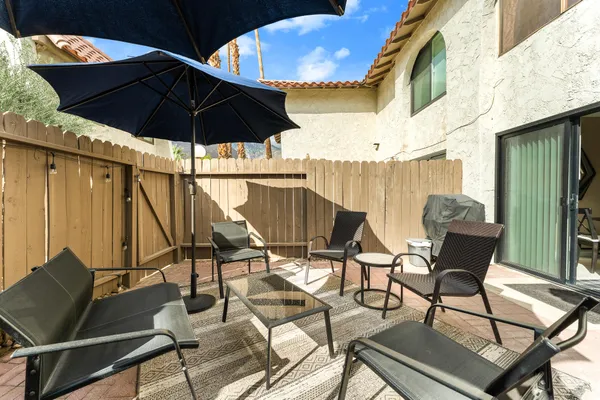 a patio with table and chairs