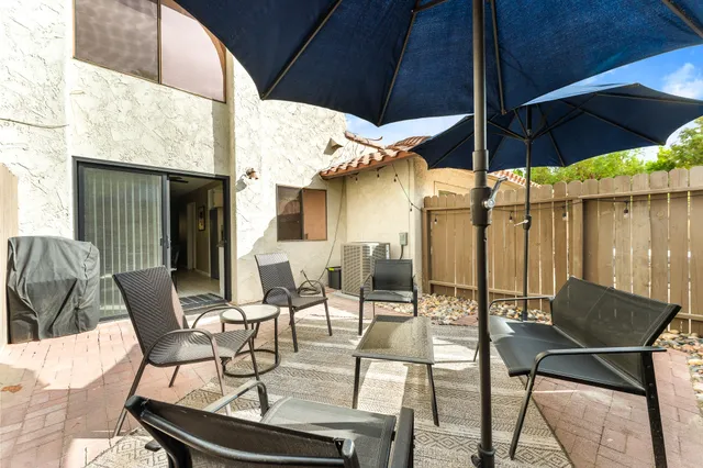 a patio with a table and chairs