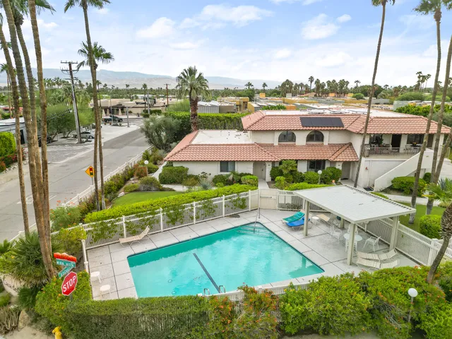 an aerial view of a house with a big yard