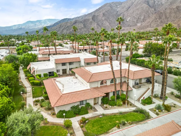 an aerial view of a house with garden space and street view