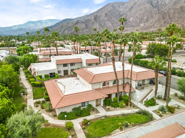 an aerial view of a house with garden space and street view