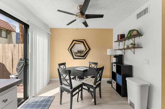 a view of a dining room with furniture and a chandelier