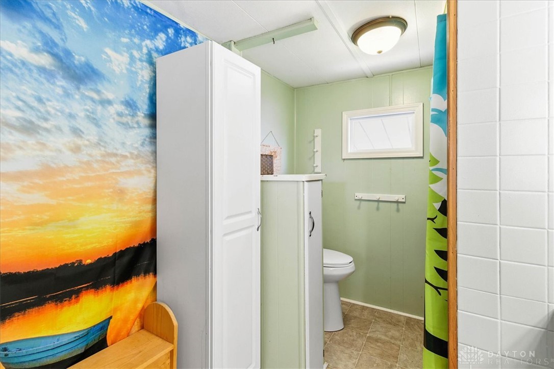 246 North Orchard Island Road Russells Point, OH 43348 - Photo 24 of 43 This functional bathroom features a tiled shower and practical storage solutions for everyday convenience.