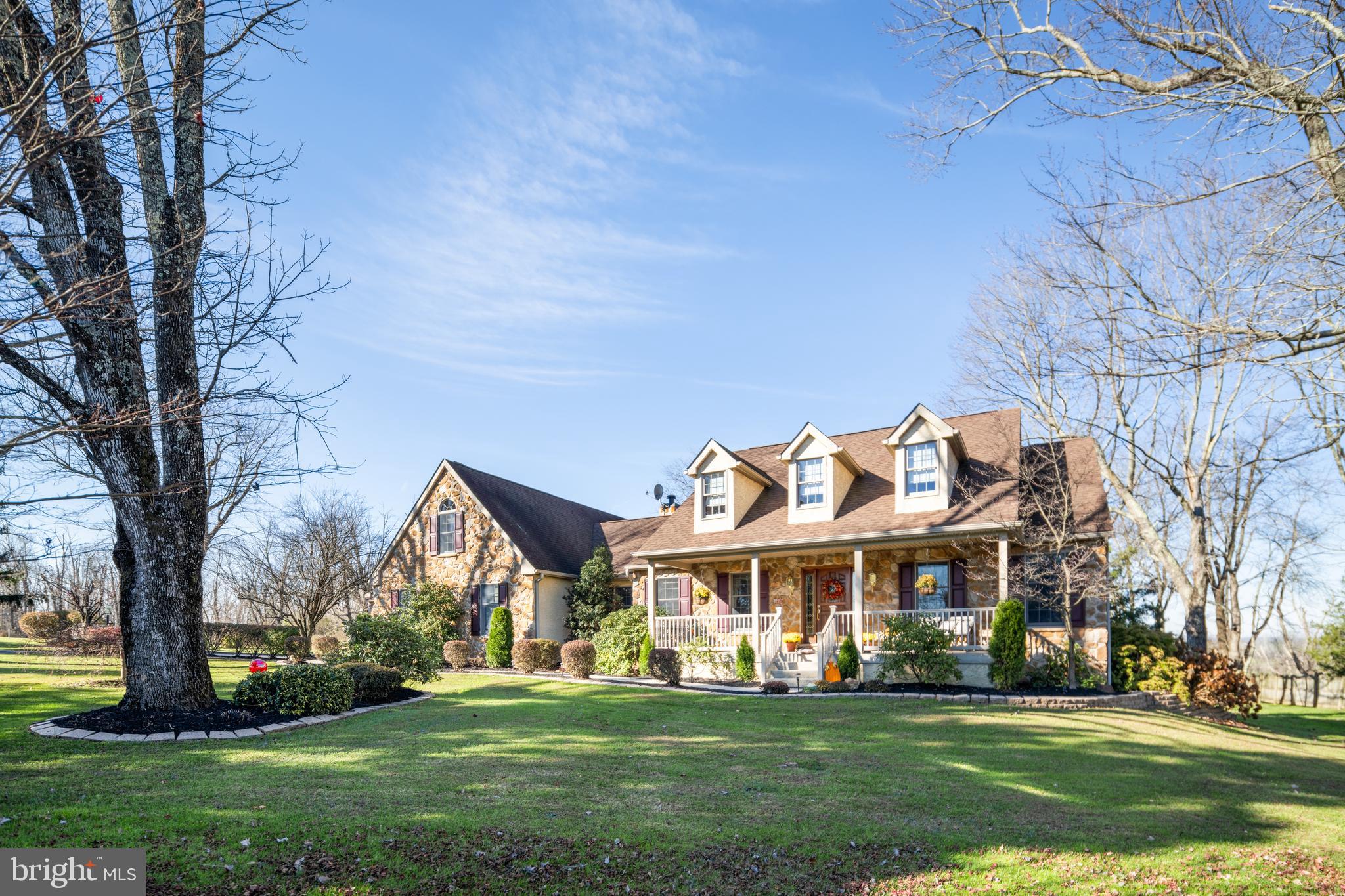 3556 Smith Road Furlong, PA 18925 - Photo 1 of 57 a view of a white house with a big yard and large trees