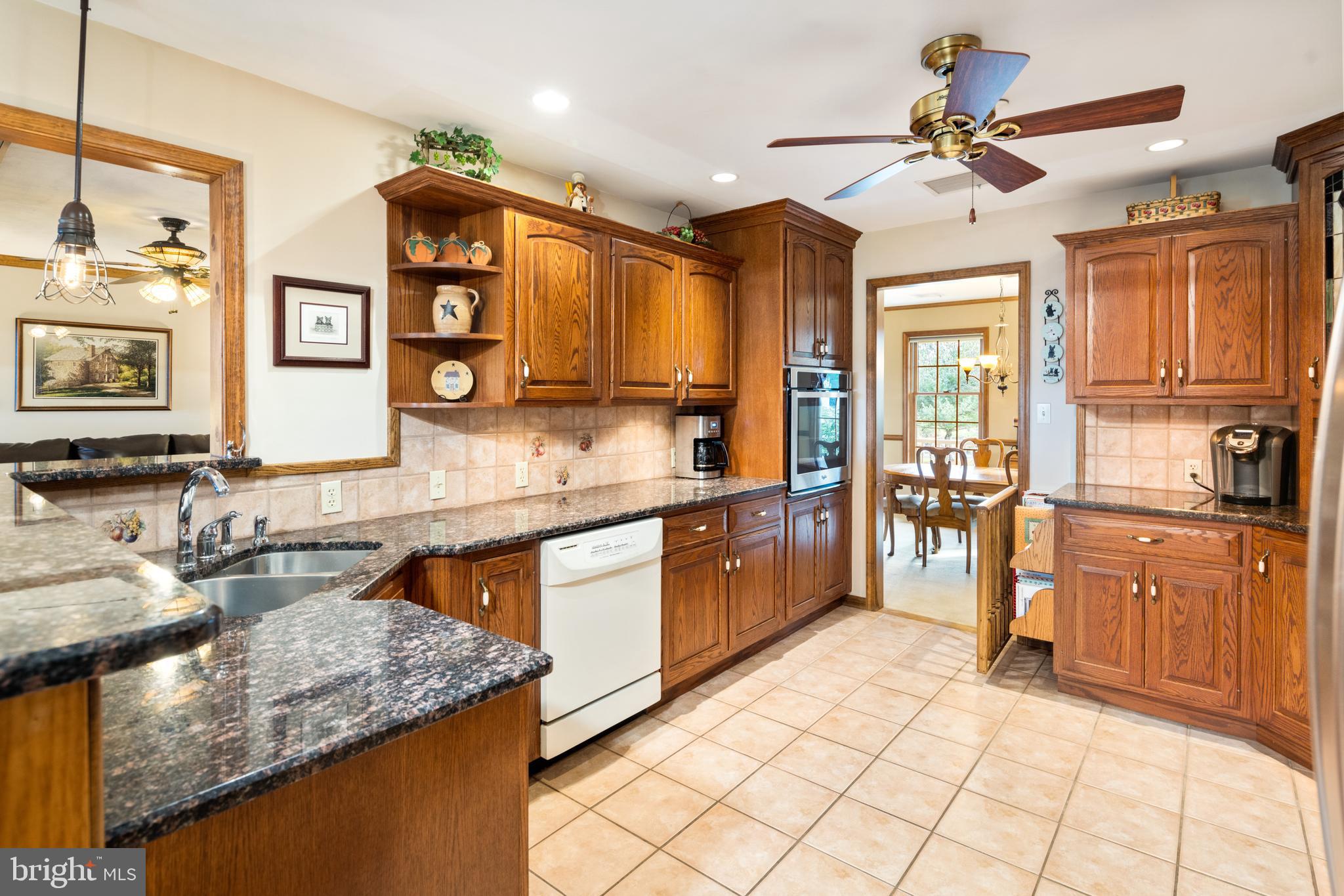 3556 Smith Road Furlong, PA 18925 - Photo 13 of 57 a kitchen with stainless steel appliances granite countertop a sink and cabinets