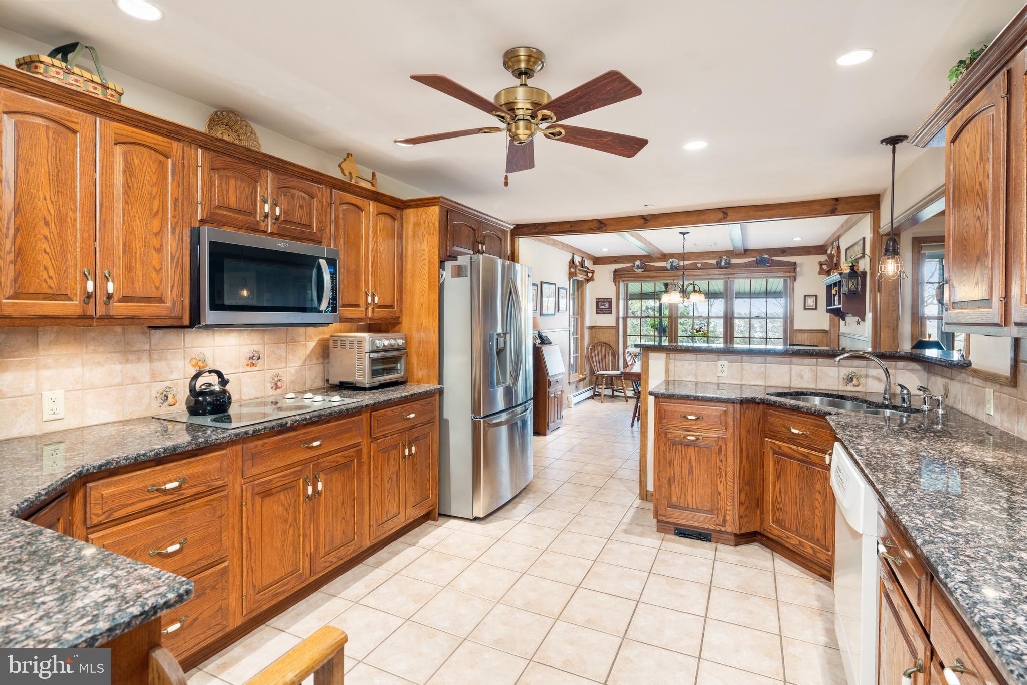 3556 Smith Road Furlong, PA 18925 - Photo 14 of 57 a kitchen with stainless steel appliances granite countertop a sink stove and refrigerator