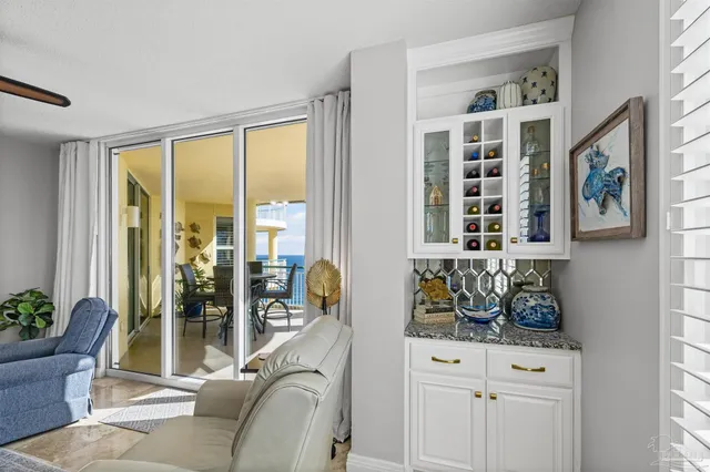 a living room with furniture lamp and windows