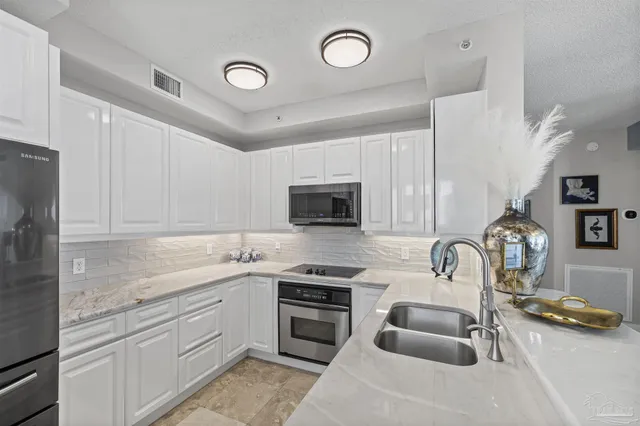 a kitchen with a sink stove and refrigerator