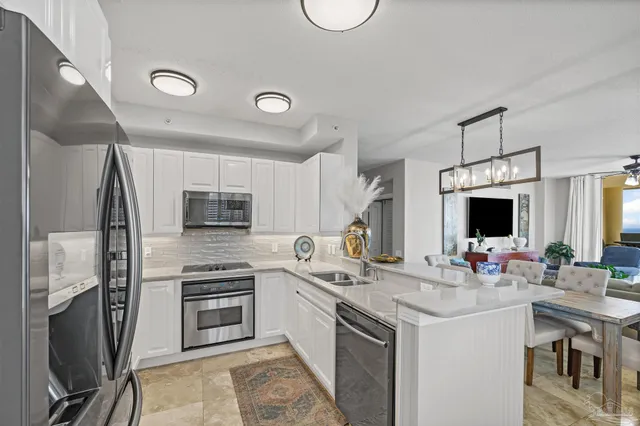 a kitchen with sink refrigerator and cabinets