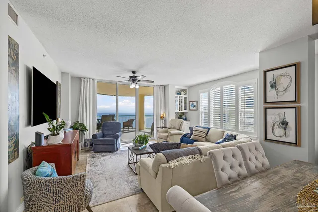 a living room with furniture large window and flat screen tv