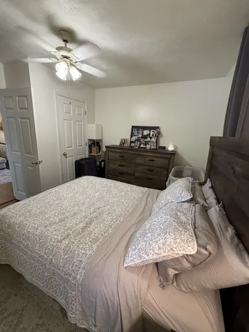 a bedroom with a bed and a chandelier