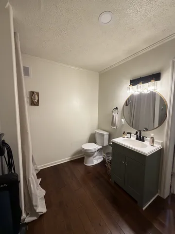 a bathroom with a sink toilet and mirror