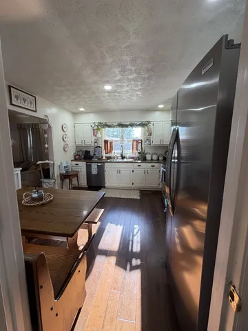 a kitchen with a sink appliances and cabinets
