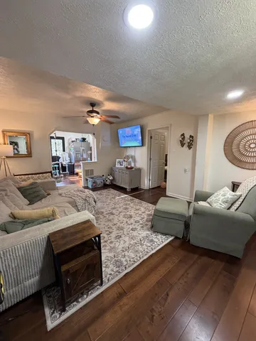 a bedroom with a bed wooden floor and furniture