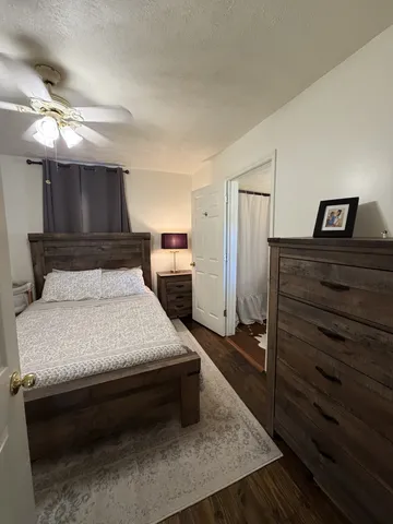 a bedroom with a bed and cabinet