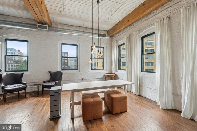 a living room with furniture window and wooden floor