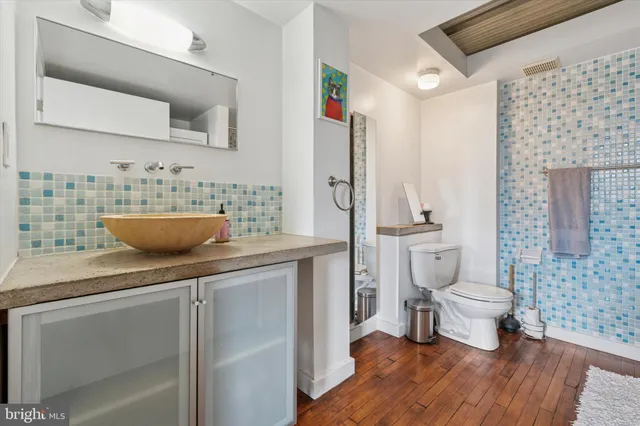 a bathroom with a toilet sink and mirror