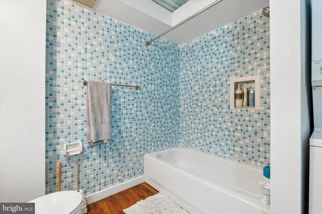 a bathroom with a bathtub and shower