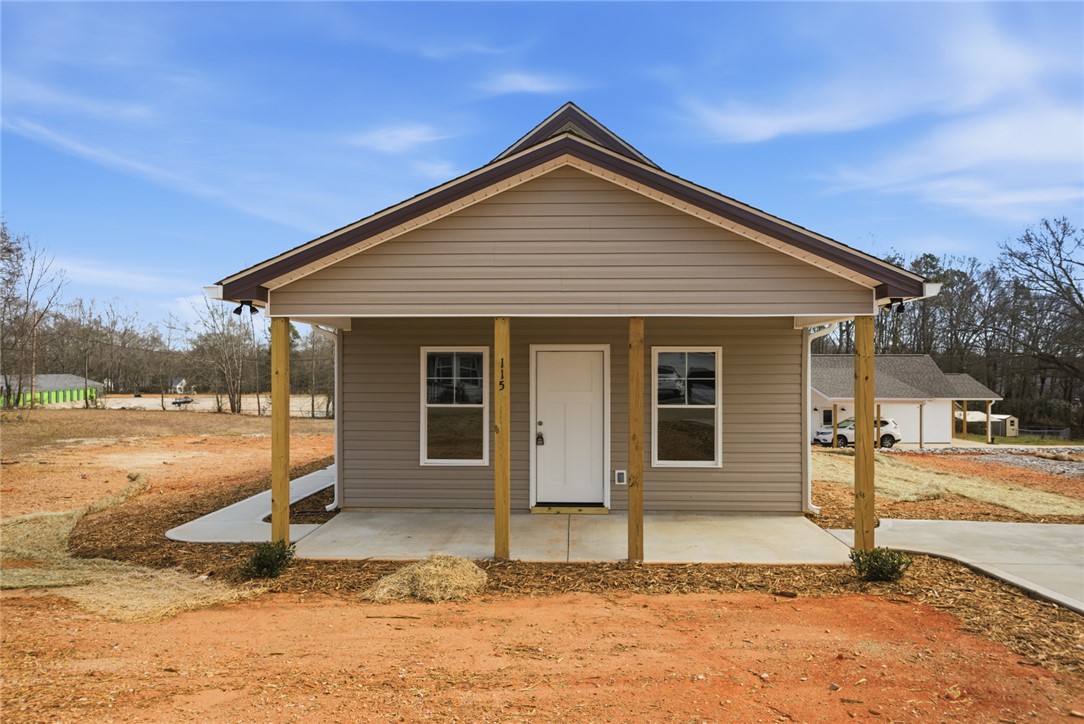 A welcoming front porch leads into this newly built single-story home.
