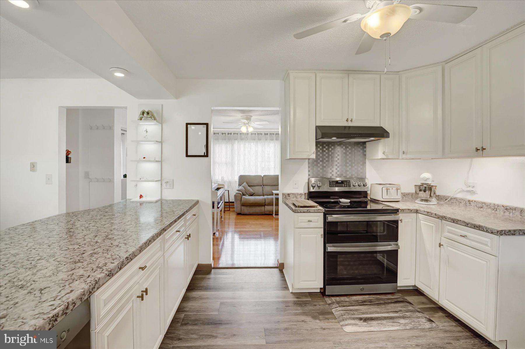 4814 West Whitehall Road Pennsylvania Furnace, PA 16865 - Photo 15 of 43 a kitchen with stainless steel appliances granite countertop a stove and a sink