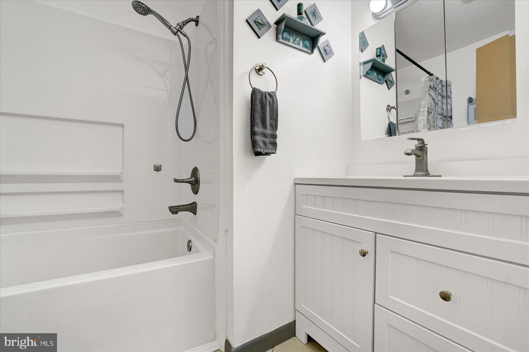 4814 West Whitehall Road Pennsylvania Furnace, PA 16865 - Photo 18 of 43 a bathroom with a bathtub sink vanity and mirror