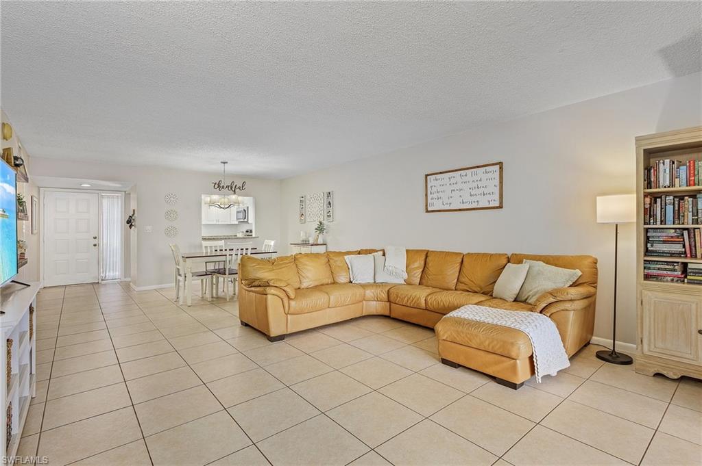 5789 Gage Lane, Unit A 103 Naples, FL 34113 - Photo 12 of 26 a living room with furniture and a couch