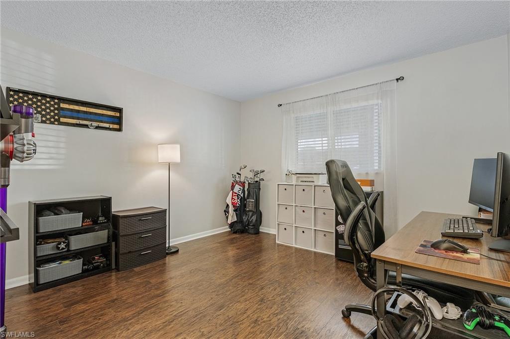 5789 Gage Lane, Unit A 103 Naples, FL 34113 - Photo 14 of 26 a view of a workspace with furniture and wooden floor