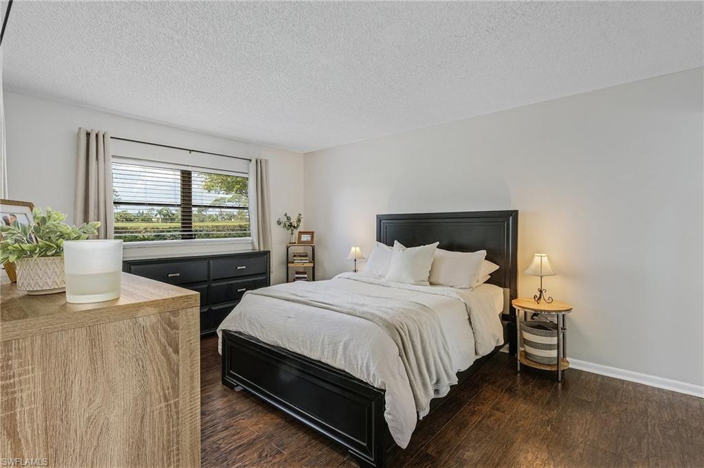 5789 Gage Lane, Unit A 103 Naples, FL 34113 - Photo 16 of 26 a bedroom with two beds and a table