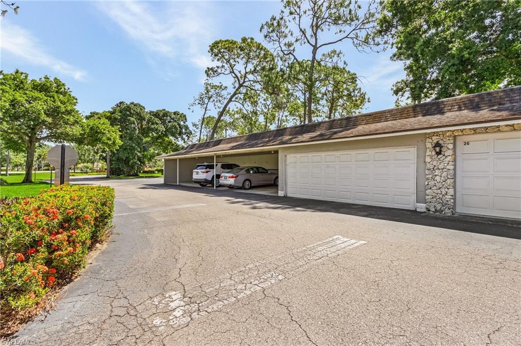 5789 Gage Lane, Unit A 103 Naples, FL 34113 - Photo 2 of 26 a front view of a building with garden