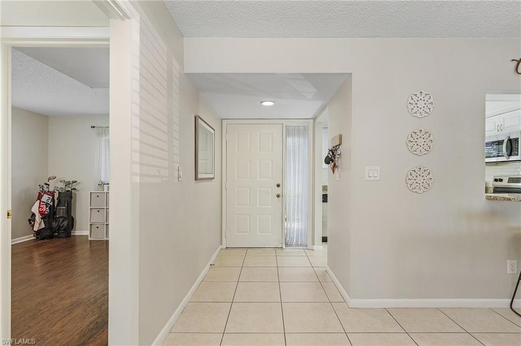 5789 Gage Lane, Unit A 103 Naples, FL 34113 - Photo 4 of 26 a view of a hallway with closet and a potted plant