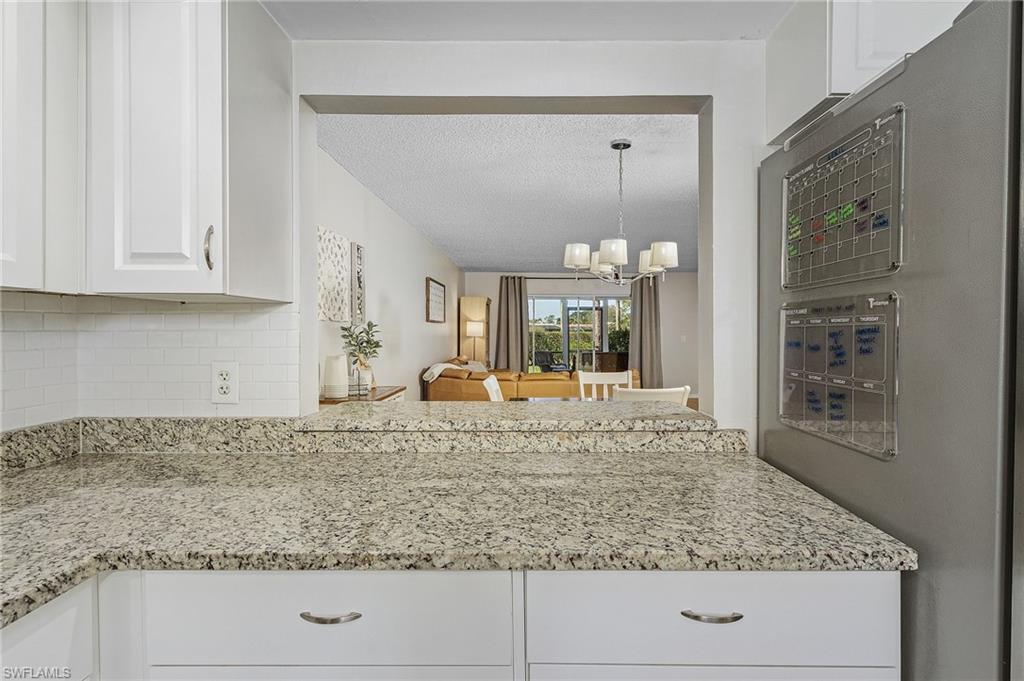 5789 Gage Lane, Unit A 103 Naples, FL 34113 - Photo 8 of 26 a view of a kitchen counter top space