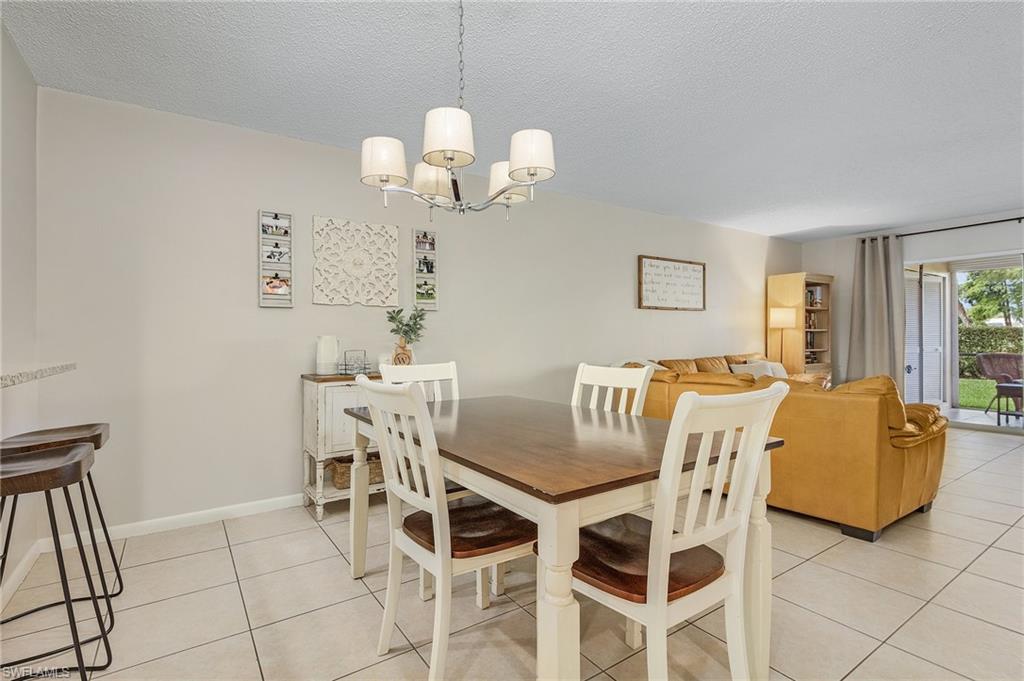 5789 Gage Lane, Unit A 103 Naples, FL 34113 - Photo 9 of 26 a view of a dining room with furniture