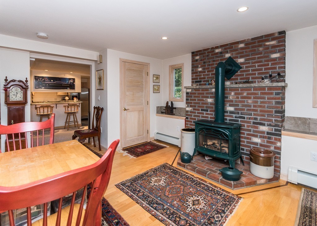 93 Old County Road Lincoln, MA 01773 - Photo 11 of 30 a living room with furniture flat screen tv and a fireplace