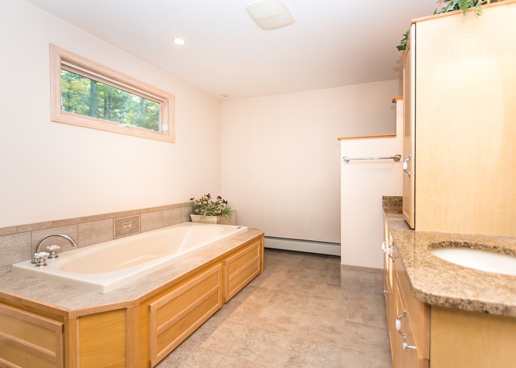 93 Old County Road Lincoln, MA 01773 - Photo 18 of 30 a bathroom with a tub sink and a mirror