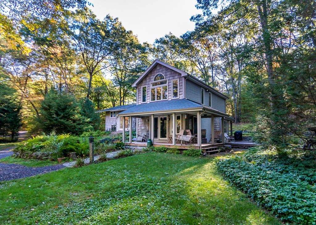 93 Old County Road Lincoln, MA 01773 - Photo 2 of 30 a front view of a house with a yard table and chairs