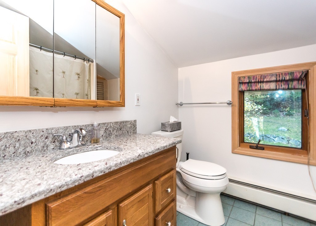 93 Old County Road Lincoln, MA 01773 - Photo 21 of 30 a bathroom with a granite countertop sink mirror vanity and toilet