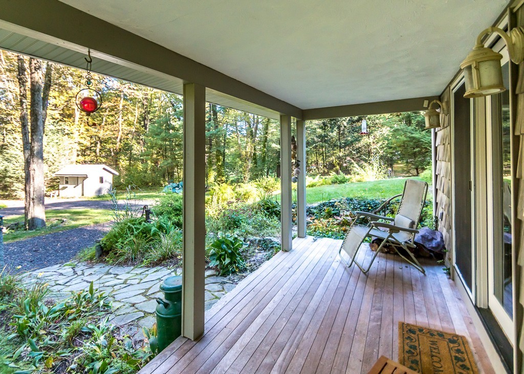 93 Old County Road Lincoln, MA 01773 - Photo 23 of 30 a view of a porch with furniture and wooden floor